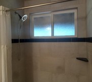 A shower with a window

Description automatically generated