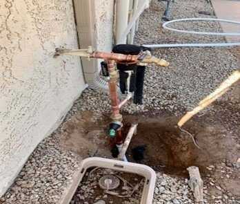 digging out a hose bib supply