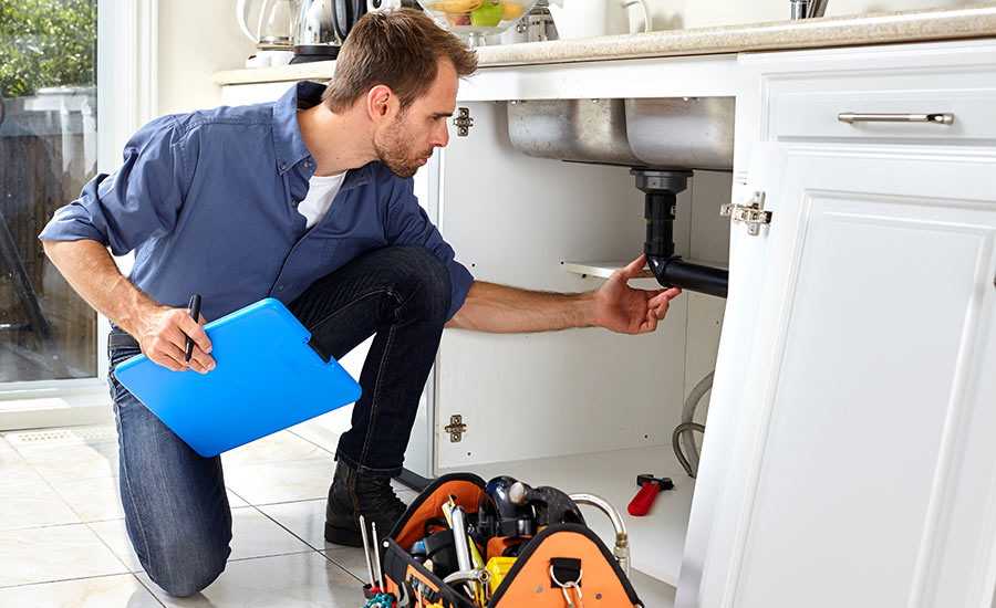 man inspecting plumbing installation
